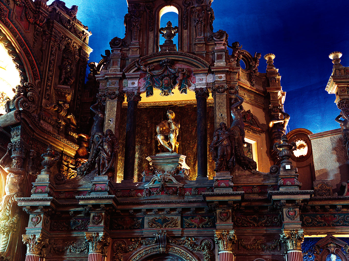 Sculpture, columns, and intricate architectural details beside the stage.