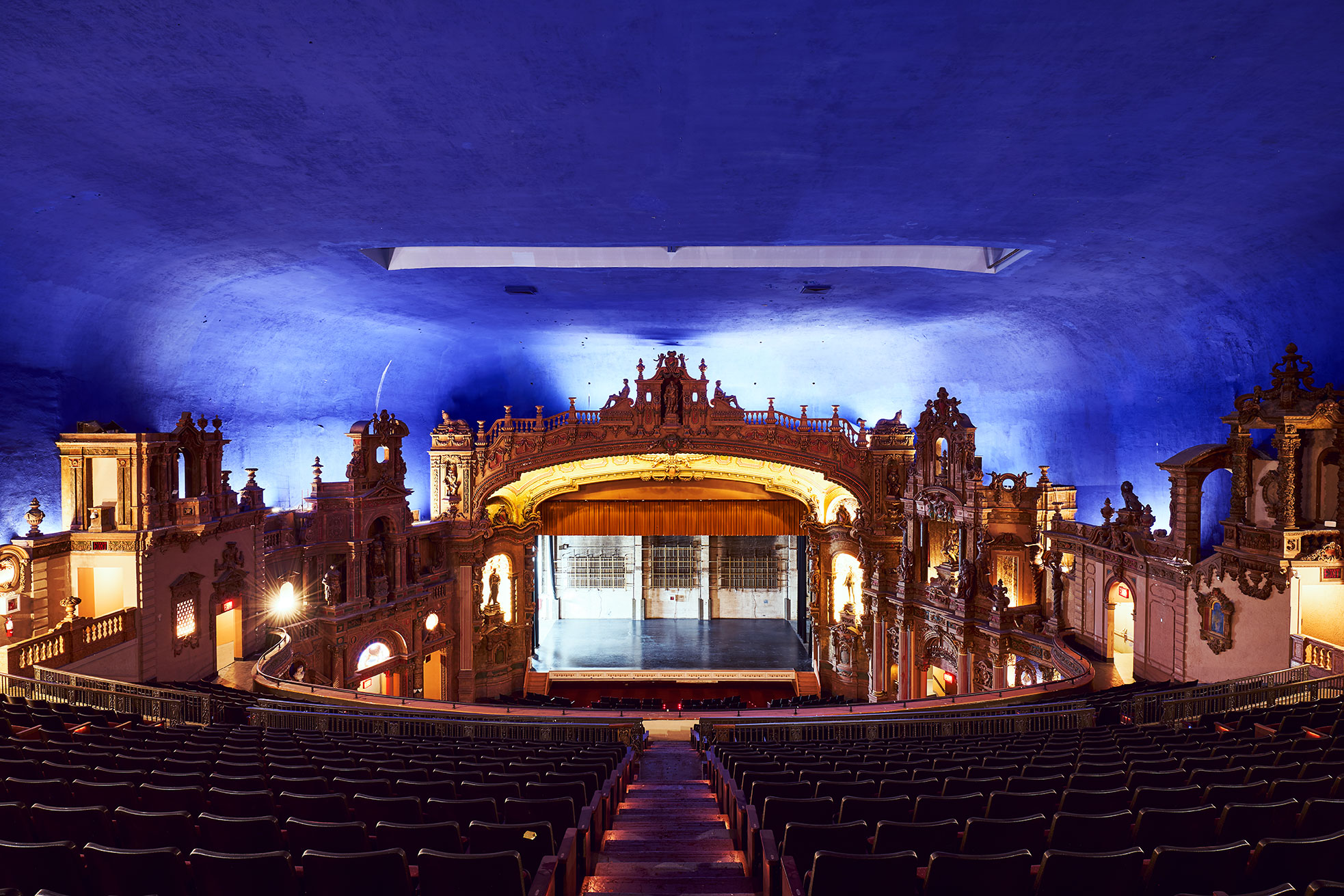 The stage and surrounding architecture seen from the rear seating area.