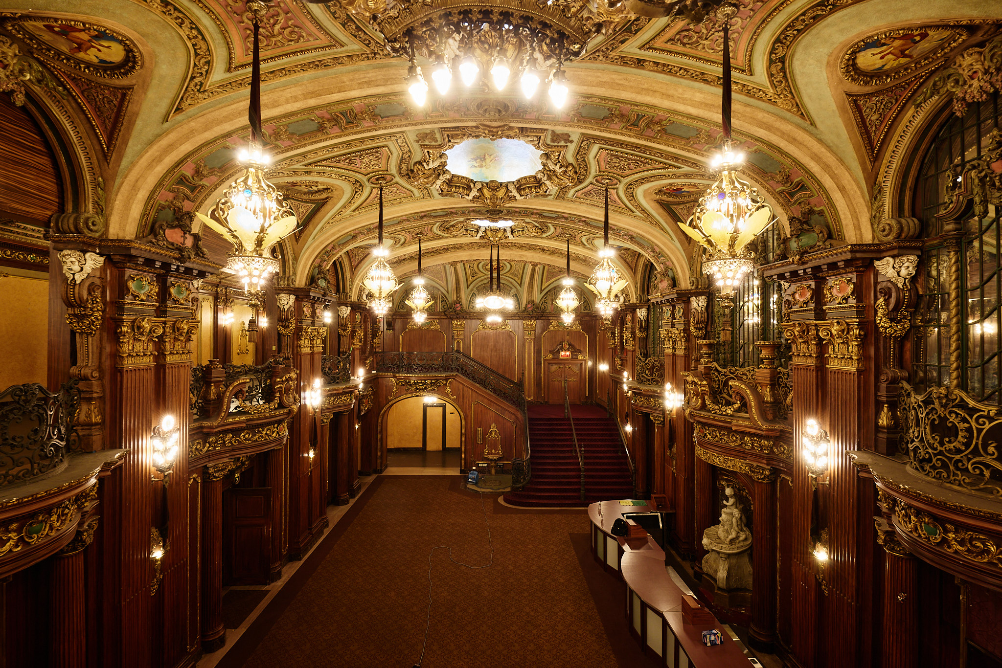 The Paradise lobby with illuminated chandeliers, painted ceilings, and gilded balconies