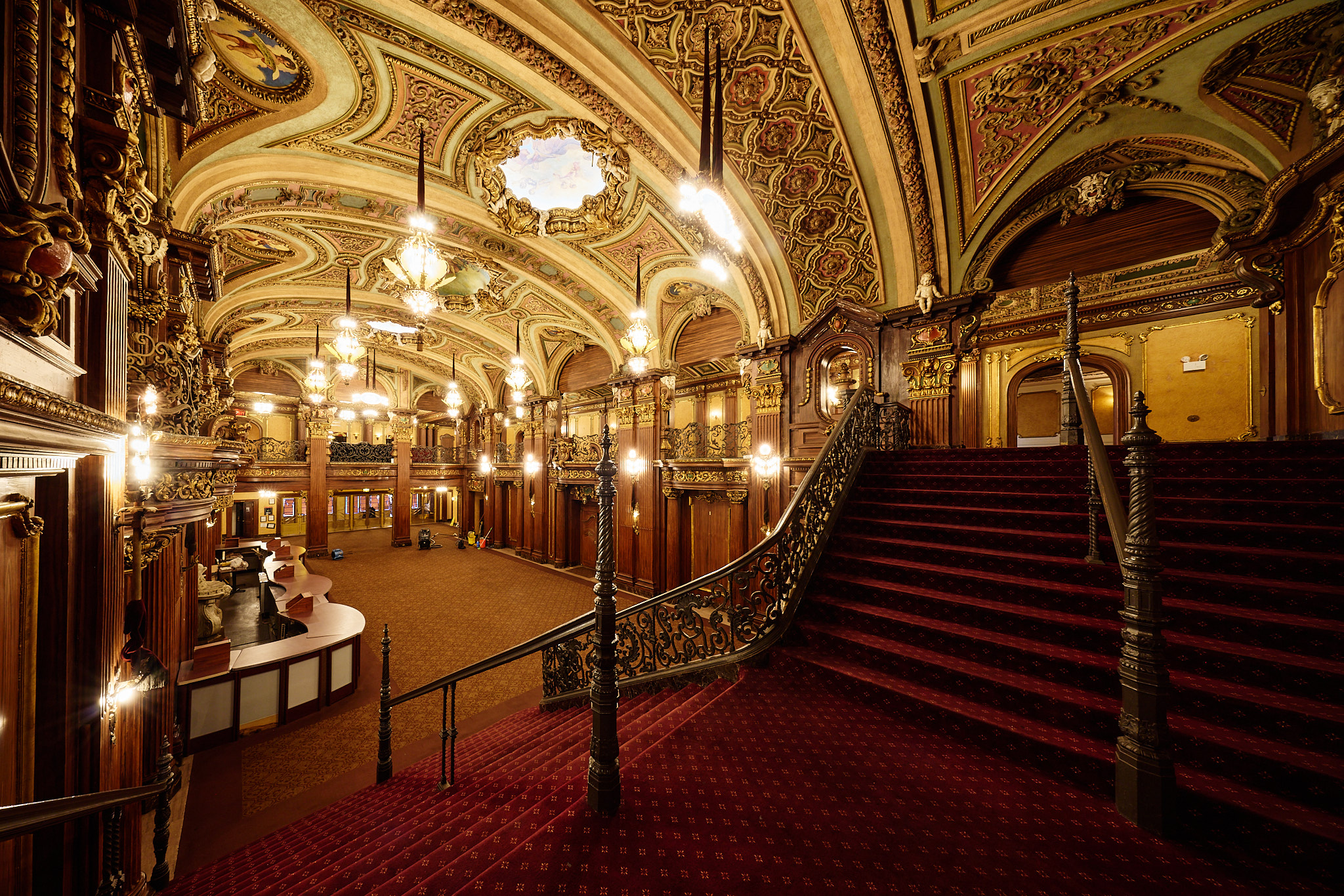 The red-carpeted grand staircase beneath the Paradise lobby’s gilded ceiling